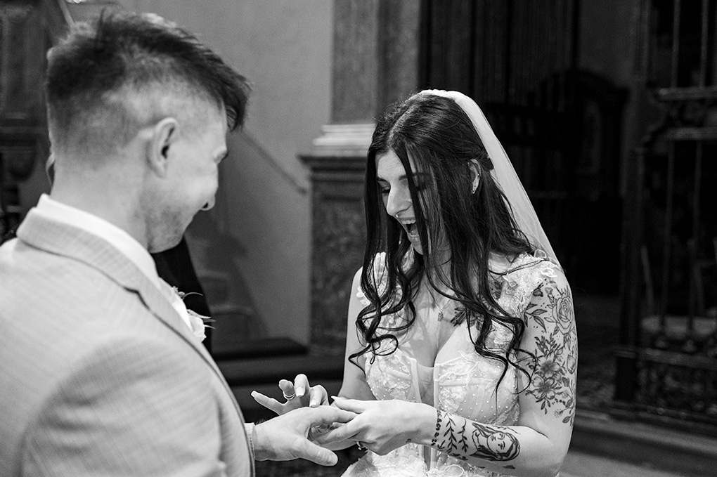 Úsmev nevesty počas výmeny prsteňov pri oltári.